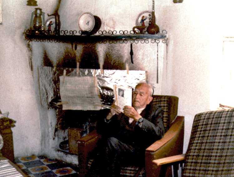 Anastasis Polis reading newspaper fireplace Anoi